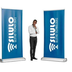 A Black Guy Standing Between Two Roll Up Banners