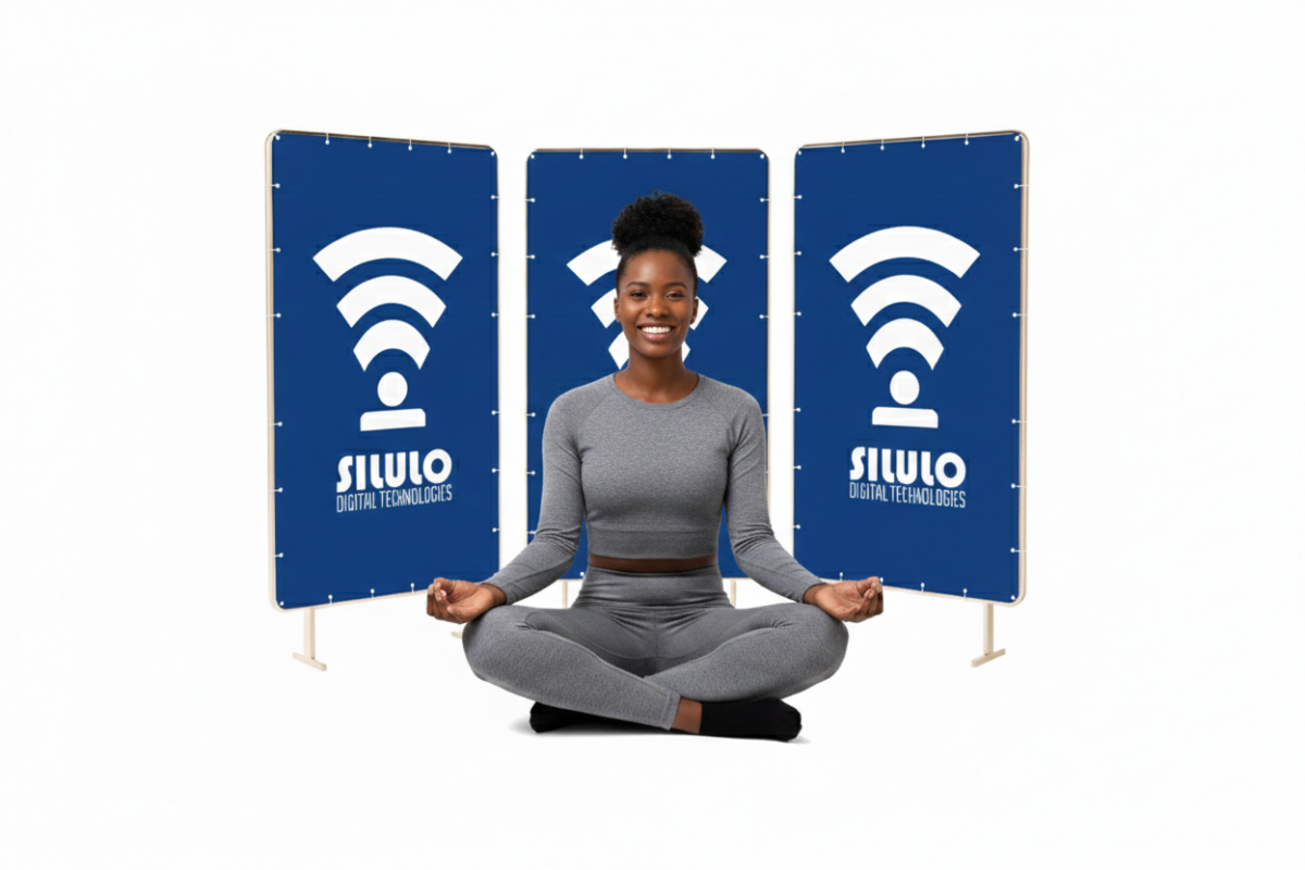 A woman sitting in front of three banners